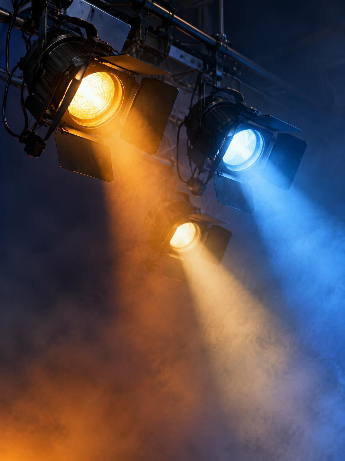 Studio spotlights on a rig with coloured gels